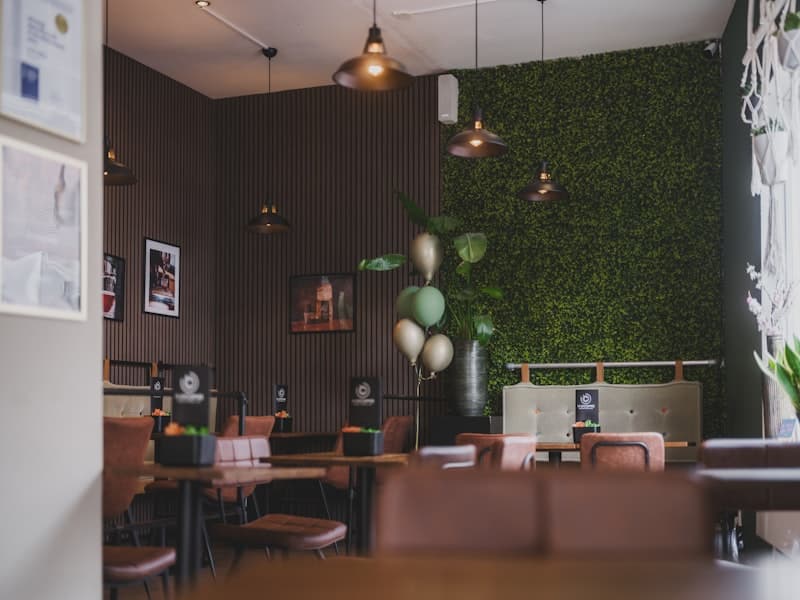 Cozy café corner — full green wall with balloon décor
